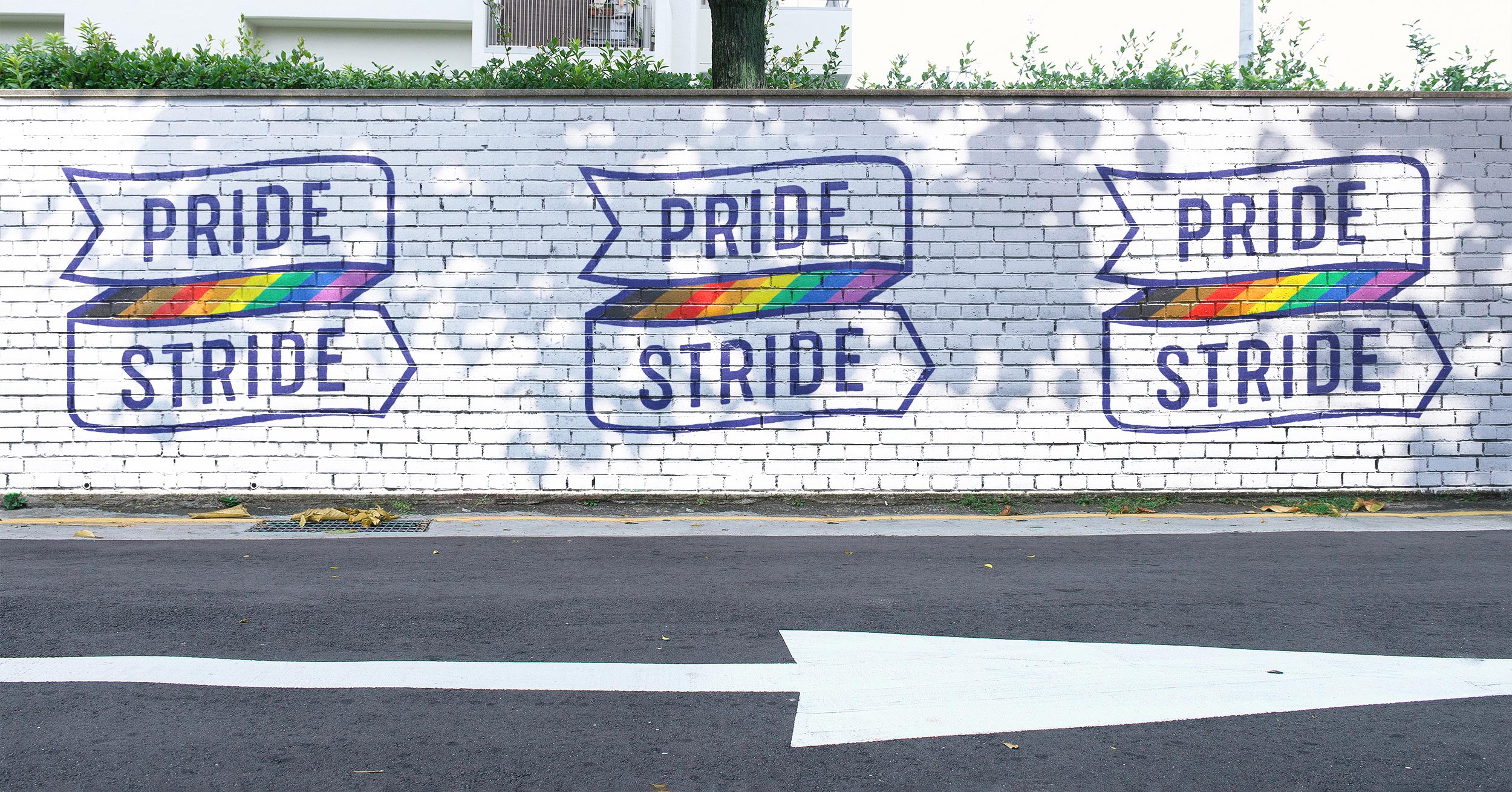 white brick wall with logo banner pride stride rainbow