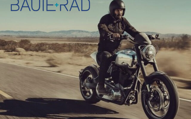 Keanu Reeves on a motorcycle on a desert road
