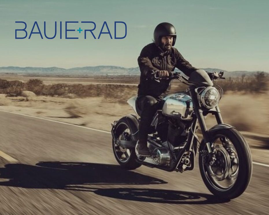 Keanu Reeves on a motorcycle on a desert road